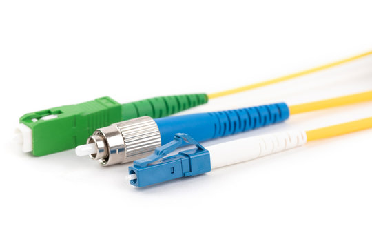 collection of different single mode fiber optic connectors isolated on white background