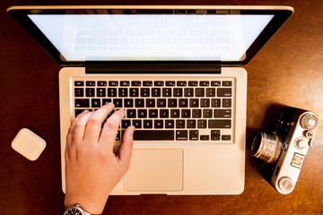 Fototapeta premium hands typing on laptop keyboard