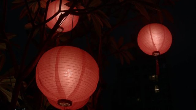 Three Chinese Lanterns at night