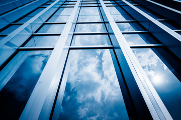 Obraz premium Clouds Reflected in Windows of Modern Office Building.