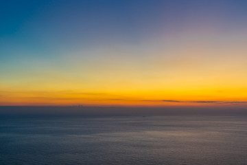 Fototapeta na wymiar Greece, Zakynthos, Aspiration for endless ocean horizon in impressive colorful sunset sky mood
