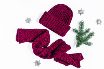 Winter purple hat with scarf on white background top view