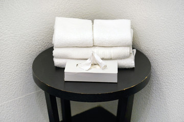 Small black table with white towels in the bathroom. Bathroom interior sink with modern design. Interior of bathroom.
