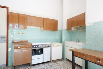Old kitchen interior with turquoise tiles in old house