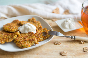 carrot pancakes with cream sauce on a plate, healthy Breakfast