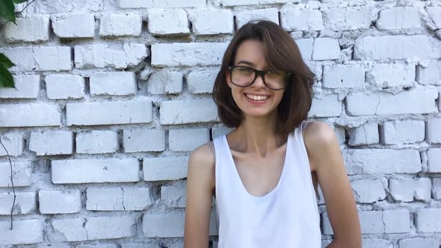 Teen girl with hipster glasses is smiling.