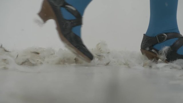 Dancing ladies feets in feathers