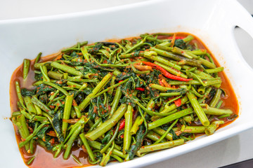 Indonesian food tumis kangkong terasi or stir fry swamp cabbage