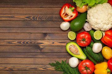Flat lay composition with assortment of fresh vegetables on wooden table. Fresh farmers garden vegetables on wooden table. Diet concept. Space for text