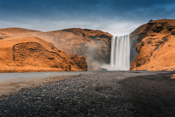 Iceland, Skogafoss waterfall in autumn. Colorful landscape. Long exposure