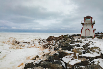Fototapeta na wymiar Frozen Atlantic Ocean off seashore at Arisaig Lighthouse in Antigonish County, Nova Scotia, NS, Canada