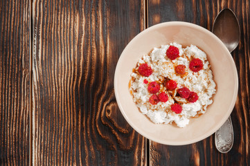 Natural fresh cottage cheese with honey and raspberries. Delicious and healthy breakfast. Top view. Copy space