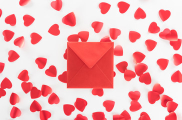 flat lay with red envelope and red heart symbols isolated on white, st valentine day concept