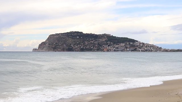 View on Bedesten Alanya fortress from Alanya beach. Island in the sea.