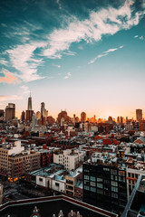 Obraz premium New York City Skyline, rooftop view, sunset, blue cloudy sky