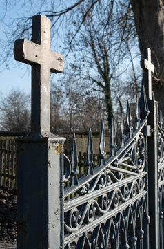 wrought-iron Gateway with small crosses at entrance  to graveyard