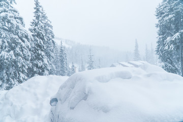 the machine is covered with snow blizzard. bad weather. a lot of snow.