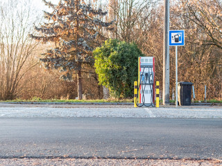 Unused Electric Vehicle charger on highway parking lot future of personal transportation and...
