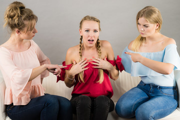 Woman being bullied by two females