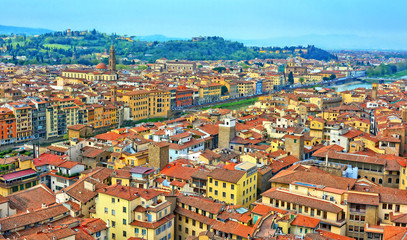 Fototapeta na wymiar Aerial view. Nice buildings with red tile roofs in the old city with hills in the background. Italian architecture. Panoramic skyline. Urban landscape. Italy, Florence