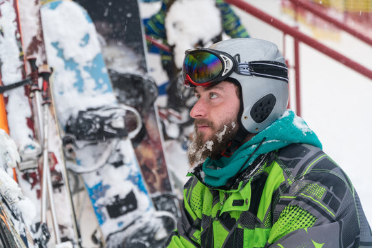 skier in the mask on the face of a snow man and snow skis.