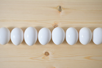 Organic white eggs on wooden table	