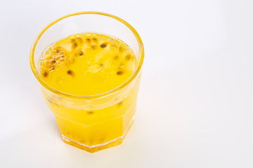 Glass of passion-fruit Juice on white background