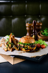 Delicious grilled burgers with beef, tomato, cheese and lettuce