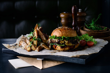 moon light burger and potatoes on a dark background