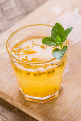 Glass of fresh passion fruit mint on table