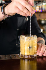 bartender at the bar stir cocktail