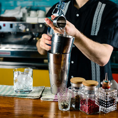 bartender at the bar making a cocktail