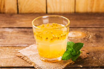 Glass of fresh passion fruit with mint on table