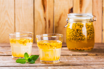 Passion fruit drinks. Homemade passion fruit in a glass jar and glasses