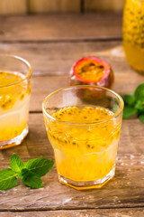 Passion fruit drinks. Homemade passion fruit in a glass jar and glasses