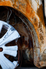 Rusted car and burnt tires