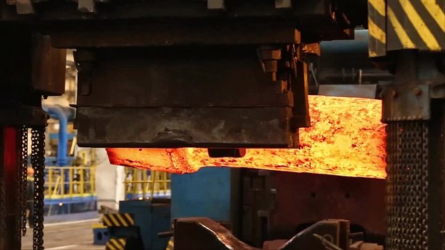 Forming a part from hot metal on the anvil using a hydraulic hammer in the forging shop of a machine-building plant