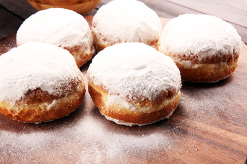 German donuts with jam and icing sugar. Carnival powdered sugar raised donuts
