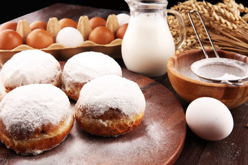 german donuts or berliner with ingredient on rustic background