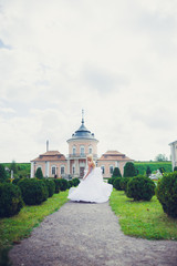 Obraz premium Beautiful blonde princess bride posing near old medieval castle