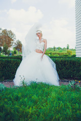 Beautiful blonde princess bride posing near old medieval castle