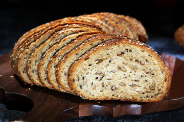 freshly baked bread on wooden board. cutted bread
