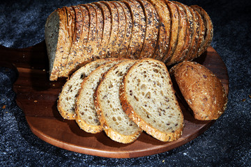 freshly baked bread on wooden board. cutted bread