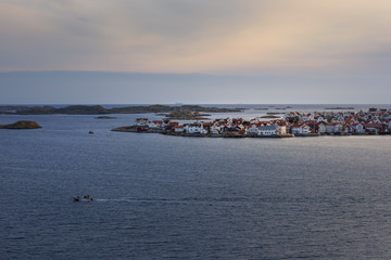 Fototapeta na wymiar Marine landscape with coastal city on an island at sunset.