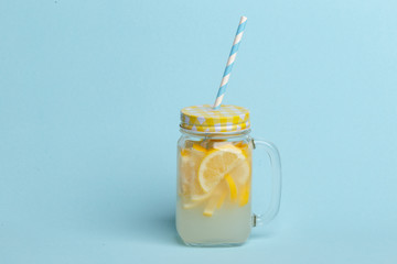 Bank with homemade lemonade on a blue background.