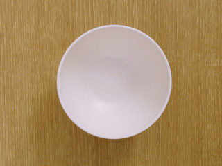 empty white plate on wooden table