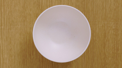 empty white plate on wooden table
