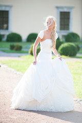 Fototapeta premium Beautiful sensual bride blonde in wedding dress 