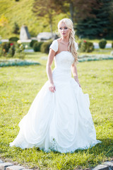 Fototapeta premium Beautiful sensual bride blonde in wedding dress 