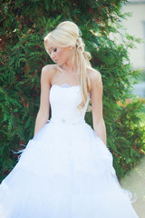 Beautiful blonde bride in fashion white wedding dress